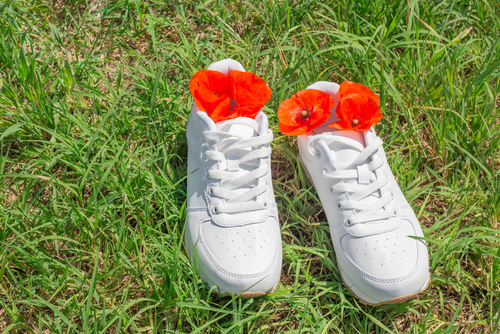 White,Sneakers,On,Green,Grass,In,Summer,,Red,Poppies,Inside.