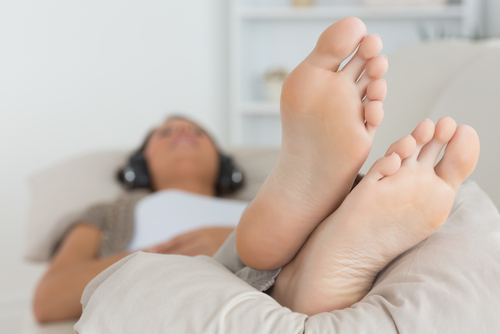 Woman,With,Her,Feet,Up,Listening,To,Music,On,The