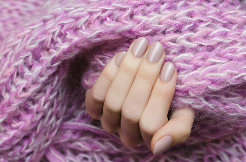 Beautiful,Female,Hand,With,Beige,Manicure,Holding,Pink,Scarf.