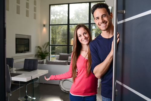 Happy,Young,Couple,At,New,House,Front,Door,Welcoming,People