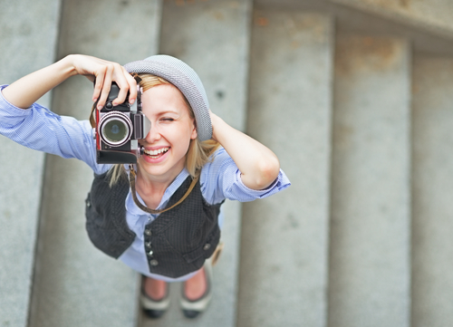 Happy,Hipster,Girl,Making,Photo,With,Retro,Camera,On,City