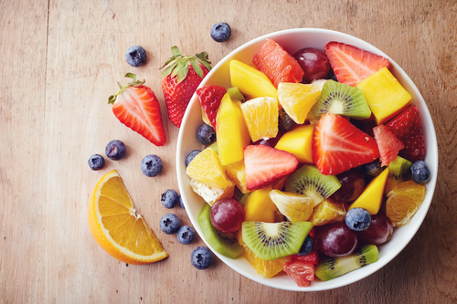 Bowl,Of,Healthy,Fresh,Fruit,Salad,On,Wooden,Background.,Top