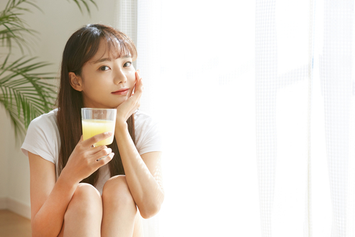 A,Young,Asian,Woman,Drinking,A,Fruit,Juice