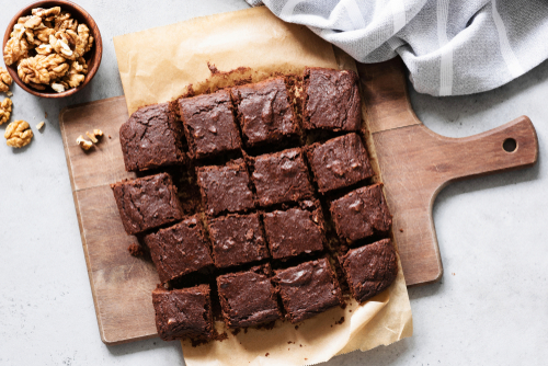 Chocolate,Brownie,Squares,With,Walnuts,On,Cutting,Board,,Top,View,