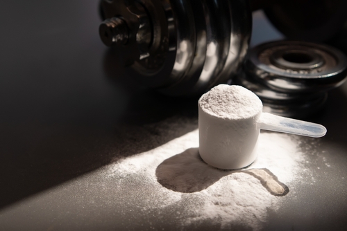 Whey,Protein,Powder,And,Dumbbell,Background,,sports,Nutrition.,Fitness,Or
