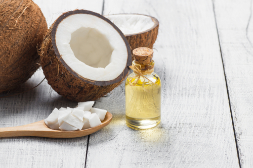 Glass,Bottle,Of,Coconut,Oil,With,Fresh,Coconut,Fruit,On