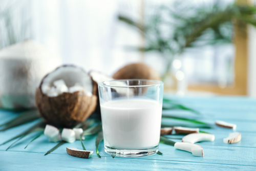 Composition,With,Fresh,Coconut,Milk,On,Wooden,Table,Against,Blurred